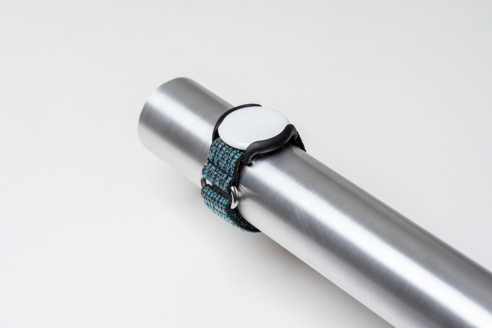 Alma Airtag frame mounted on a blue pipe